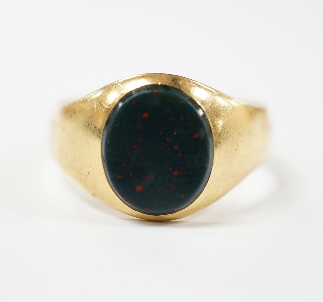 An 18ct gold and single stone oval bloodstone set signet ring, size Z+++++